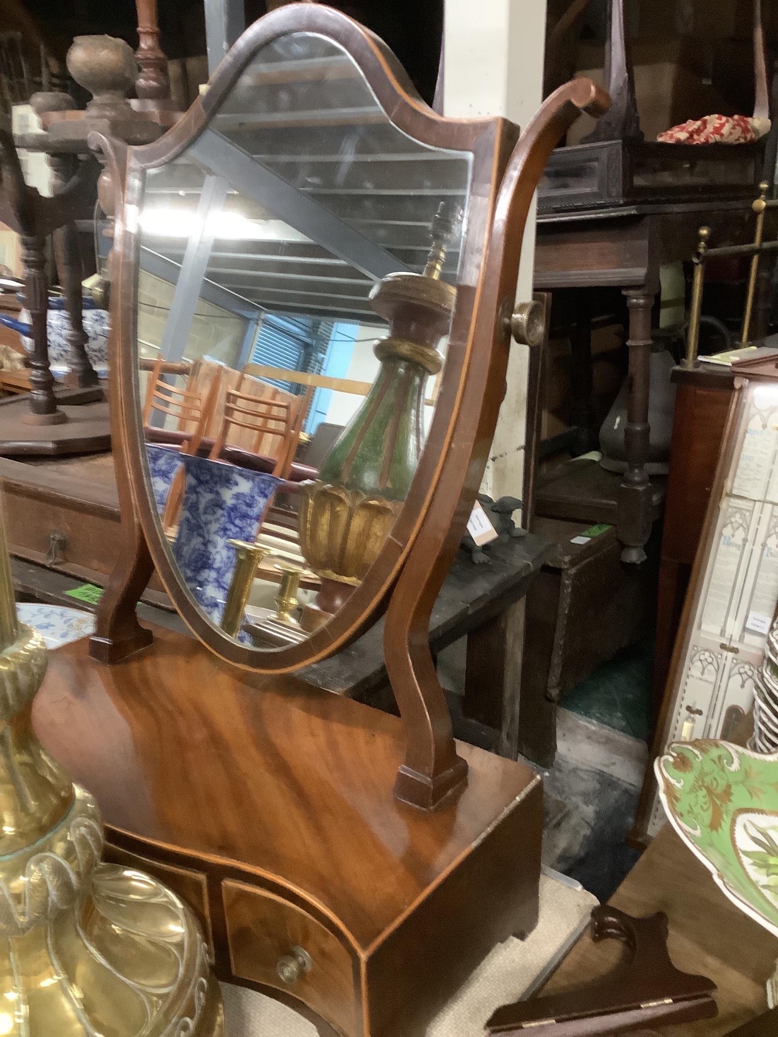 A George III serpentine mahogany toilet mirror, width 45cm, depth 21cm, height 68cm